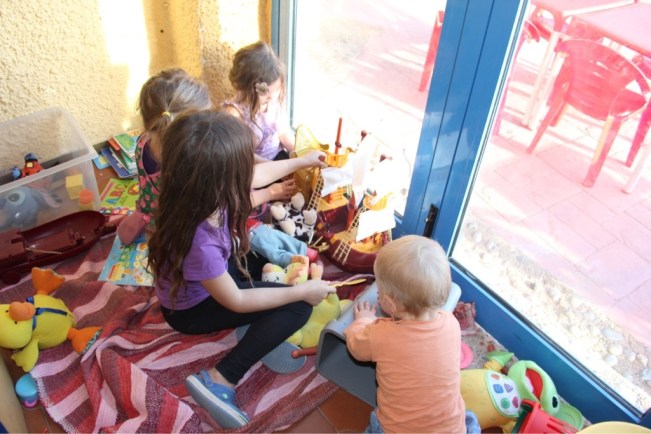 Esmeralda, Penelope, Léonie und Phileas in ihrer Spielecke in der Campingbar